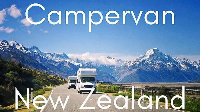 two campers travel through the mountains of New Zealand in a campervan