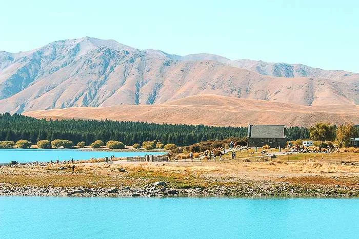 The Church of the Good Shephard against a backdrop of mountains.